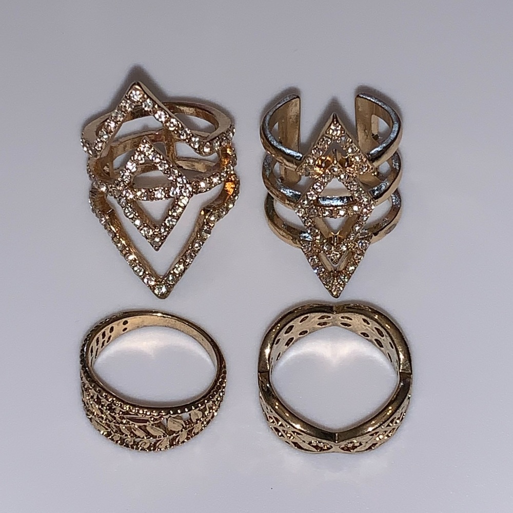 Four gold tone rings size 7
